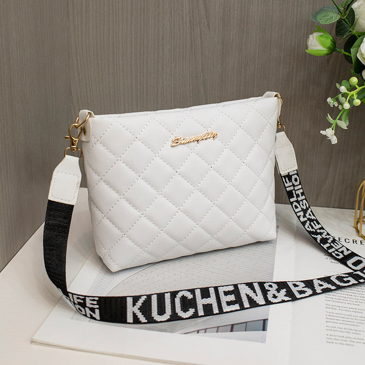 Black quilted crossbody bag with wide strap