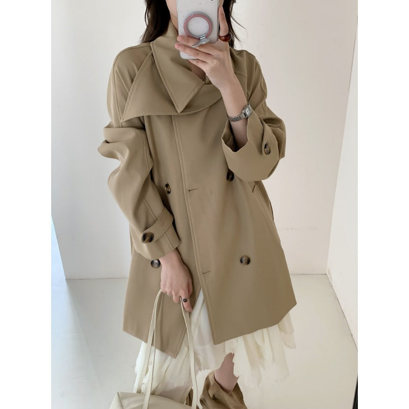 Women’s short trench coat with extra wide lapels, raglan sleeves, and horn button details