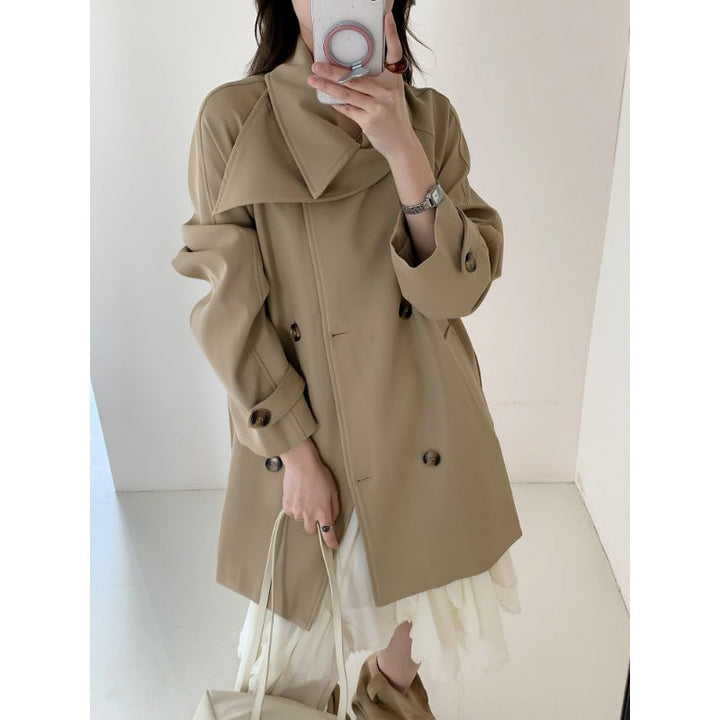 Women’s short trench coat with extra wide lapels, raglan sleeves, and horn button details