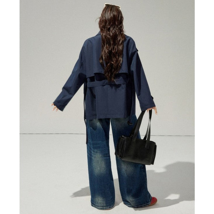 Ladies short trench coat with a flattering belt and double-breasted button placket