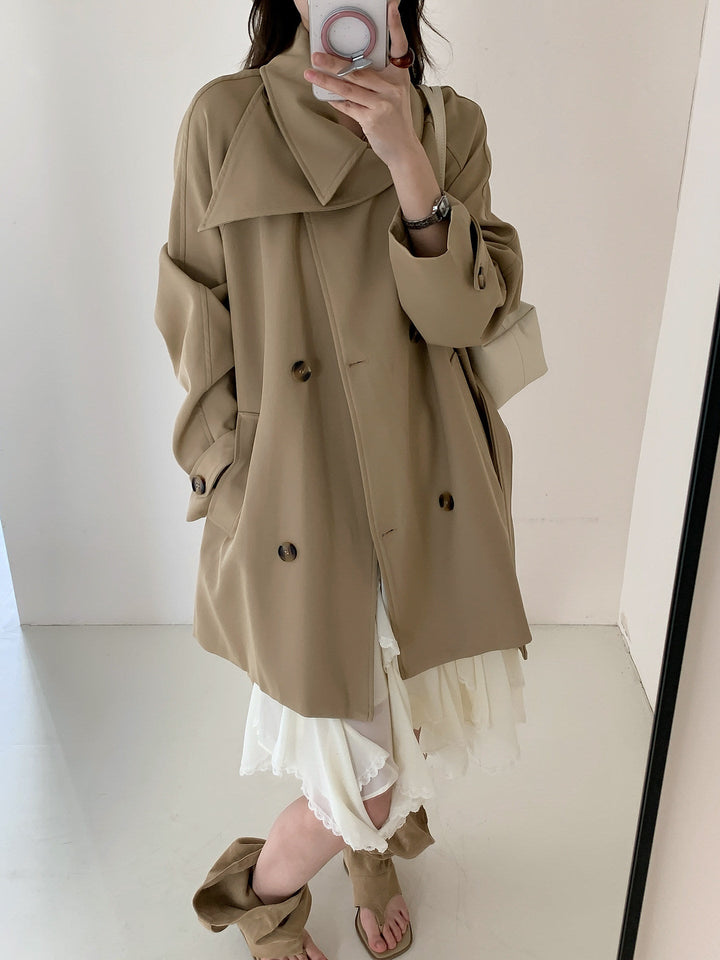 Women’s short trench coat with extra wide lapels, raglan sleeves, and horn button details