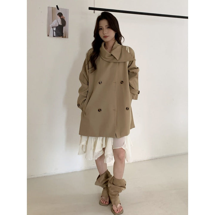 Women’s short trench coat with extra wide lapels, raglan sleeves, and horn button details