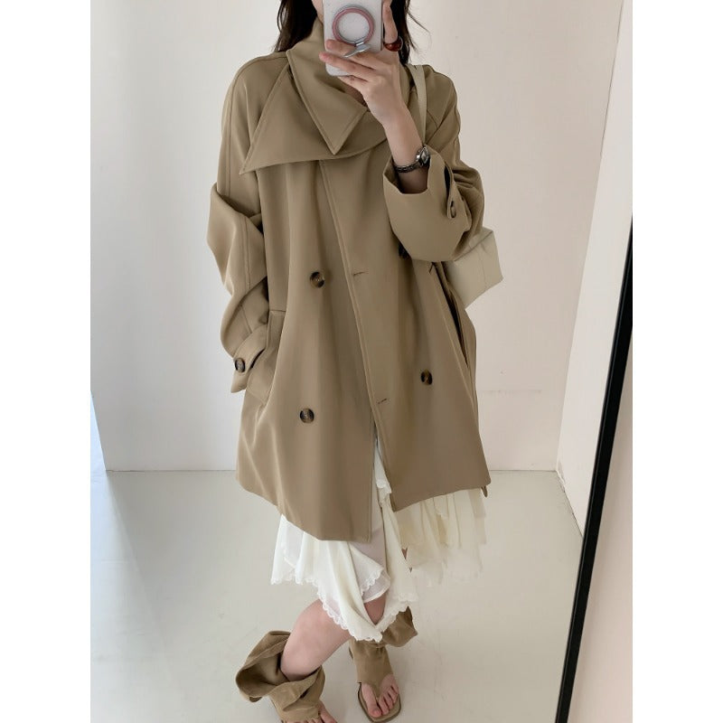 Women’s short trench coat with extra wide lapels, raglan sleeves, and horn button details