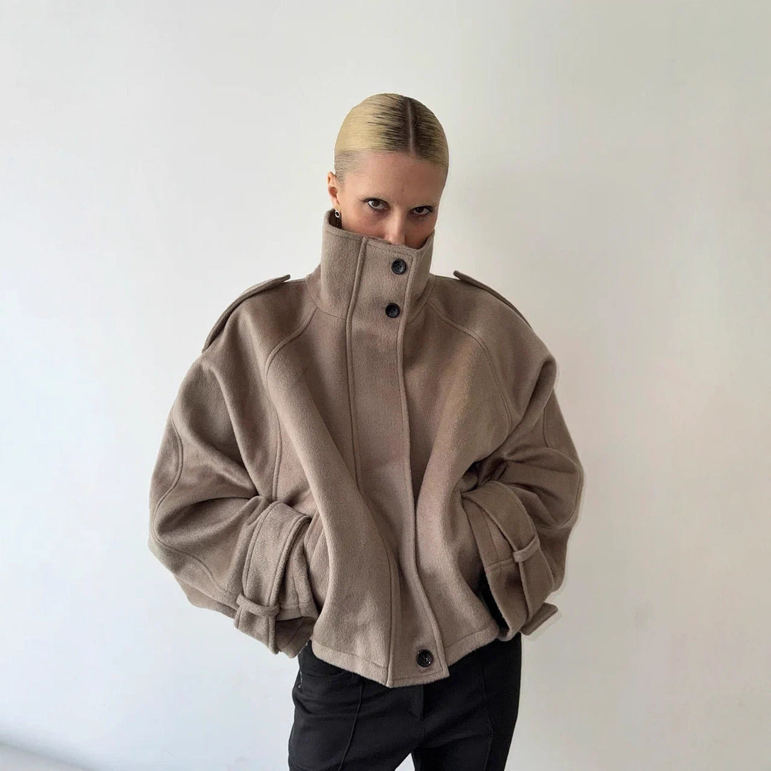 Ladies short cut oversized wool jacket with high stand-up collar, shoulder flaps and adjustable sleeve straps