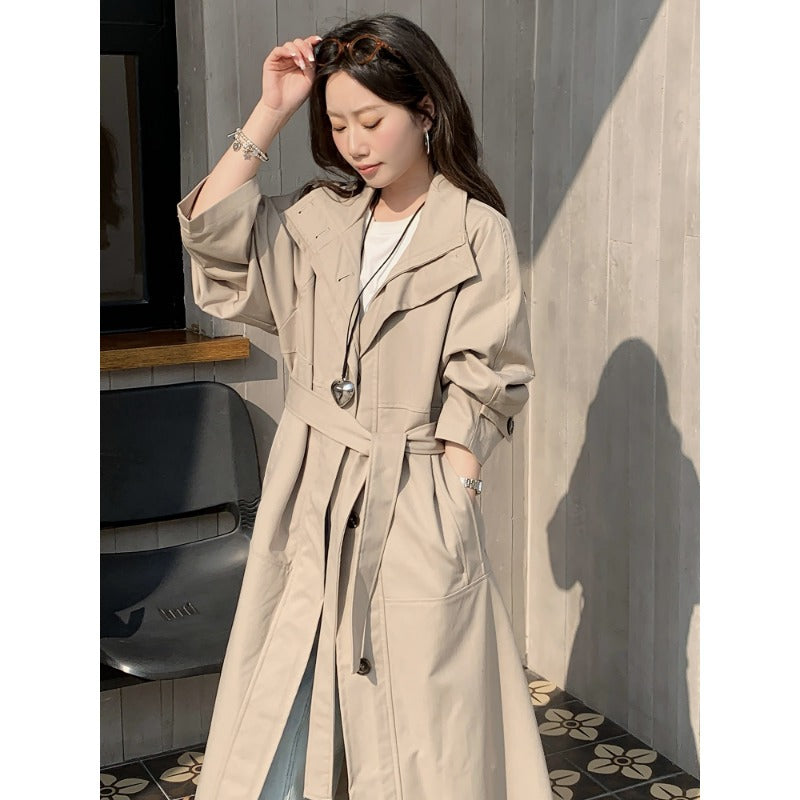 Women’s longer lighter trench coat in oversized style with straight cut and concealed button placket