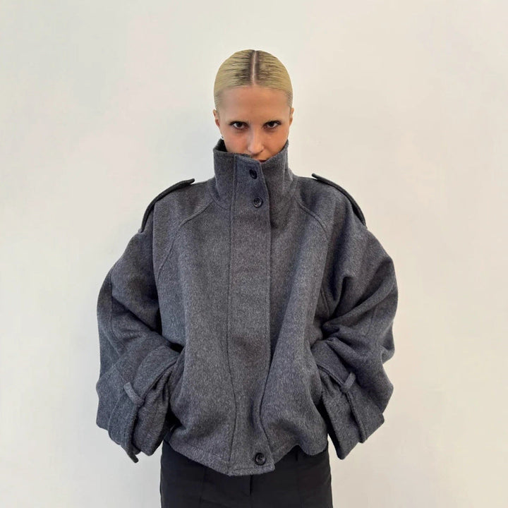 Ladies short cut oversized wool jacket with high stand-up collar, shoulder flaps and adjustable sleeve straps