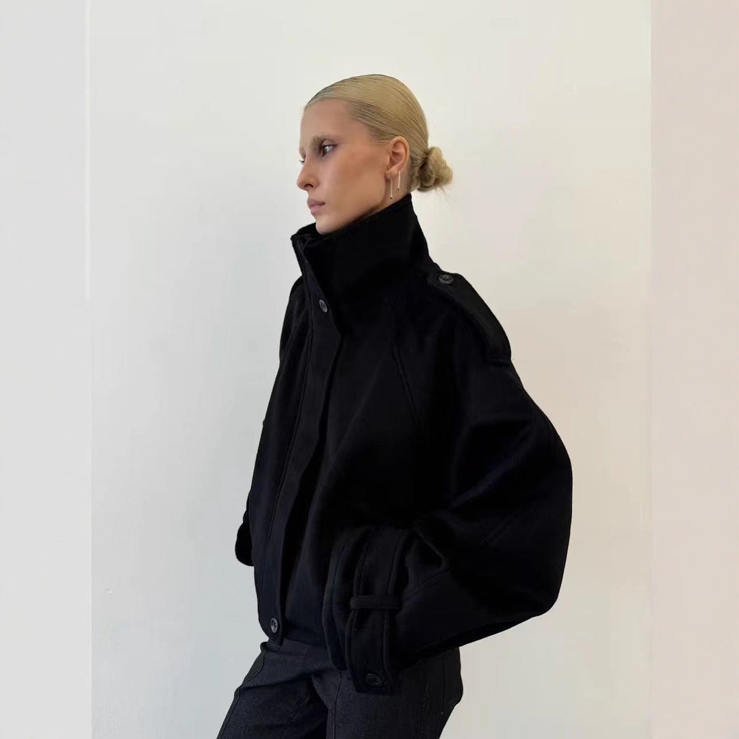 Ladies short cut oversized wool jacket with high stand-up collar, shoulder flaps and adjustable sleeve straps