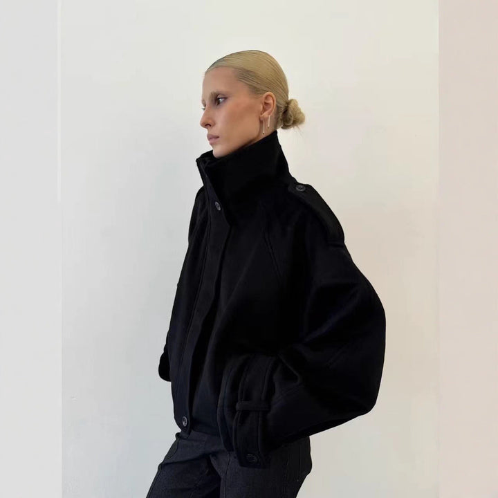 Ladies short cut oversized wool jacket with high stand-up collar, shoulder flaps and adjustable sleeve straps
