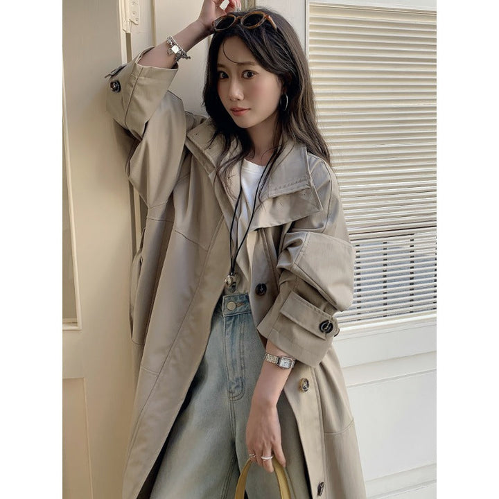 Women’s longer lighter trench coat in oversized style with straight cut and concealed button placket