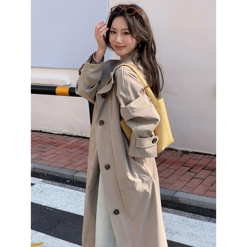 Women’s longer lighter trench coat in oversized style with straight cut and concealed button placket