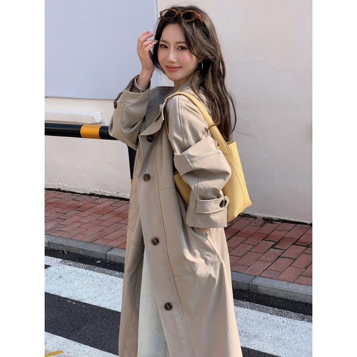 Women’s longer lighter trench coat in oversized style with straight cut and concealed button placket