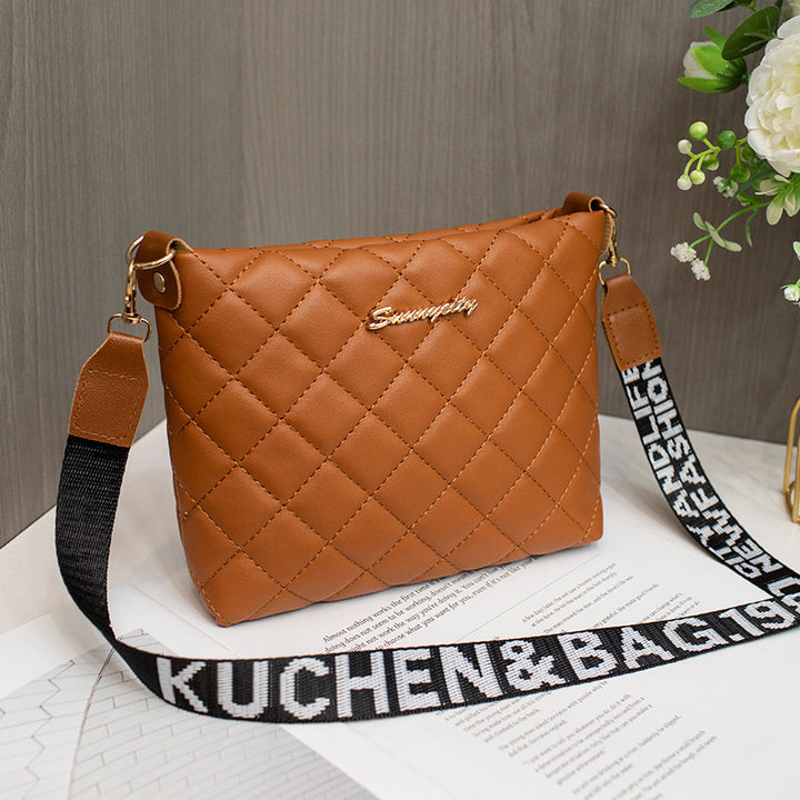 Black quilted crossbody bag with wide strap